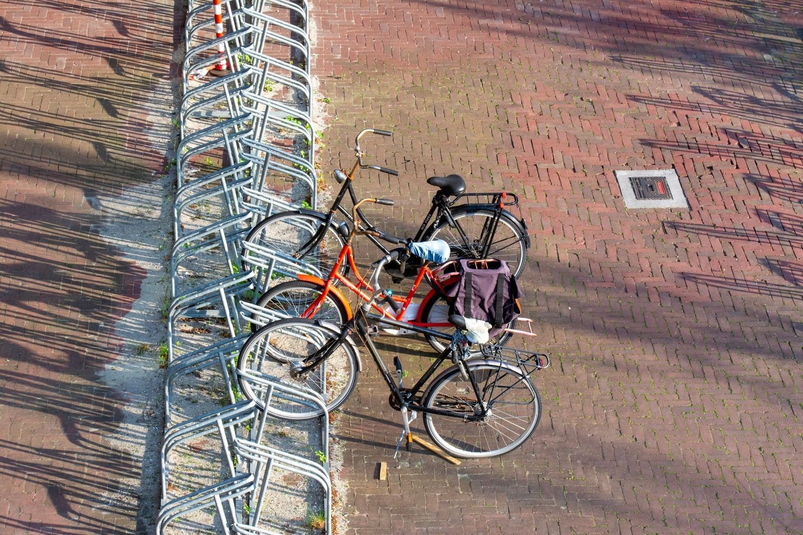 Râteliers à vélos et bicyclettes sur un pavage de briques